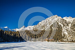 Mountain landscape with frozen tarn at winter season