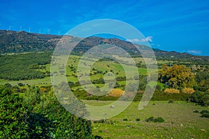 Mountain landscape with green meadows and blue sky