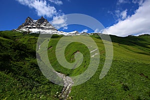 Mountain landscape with green meadows and sunshine