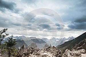 Mountain landscape with grey sky and clouds.