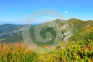 Mountain landscape on a hiking trail in the Low Tatras, Slovakia. View of mountain peaks and valleys while hiking along a mountain