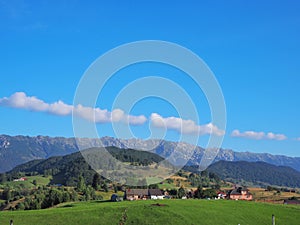 Mountain landscape with hills and tilted line of clouds