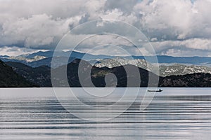 Mountain landscape lake fisherman