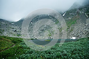 Mountain landscape. Lake, rocky mountains and clouds