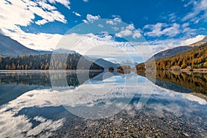 Mountain landscape with a lake where clouds are reflected