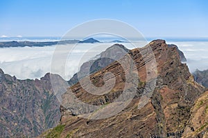 Mountain landscape with low-slung clouds at Madeira seen from Pico do Arieira