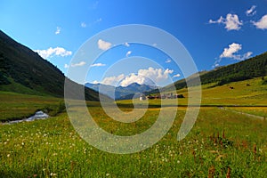 Mountain landscape with municipality of Sertig Dorfli photo