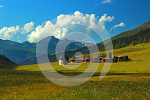 Mountain landscape with municipality of Sertig Dorfli photo