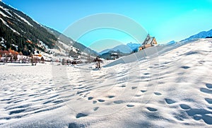 Mountain landscape, picturesque snow footprints in the winter morning panoramic church