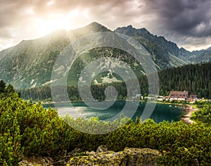 Mountain landscape with pond and mountain chalet