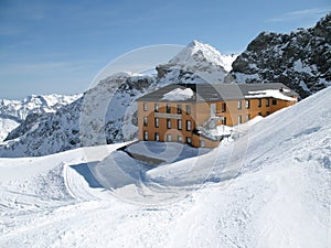 Mountain landscape and the Rifugio Guglielmina mountain hut in the Monte Rosa mountain range in the Alps of Italy
