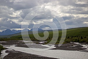 Mountain landscape with river and clouds in Denali National Park and Preserve