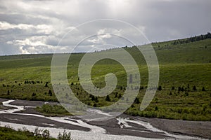 Mountain landscape with river and clouds in Denali National Park and Preserve Alaska