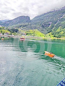 Mountain landscape with a river and Cruise ship in the fjord in Norway