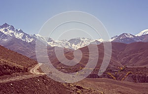 Mountain landscape with road running through wasteland.