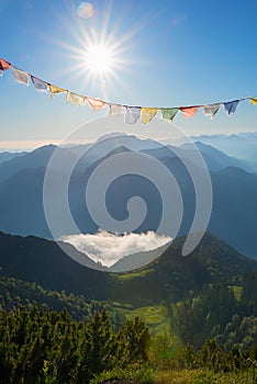 Mountain landscape with row of flags, bright sunshine in the bavarian alps