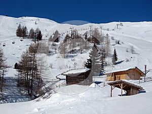 Mountain landscape with snow and wooden houses