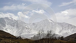 Mountain landscape. Stunning bird's-eye view of a high snow-capped mountain peak