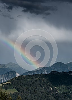 Mountain landscape after a summer thunderstorm with a rainbow