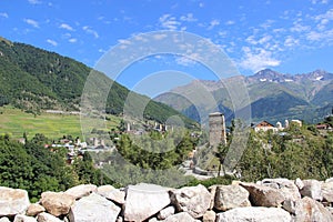 Mountain landscape. Svaneti. Svan tower against the background of a mountain landscape on a clear summer day.