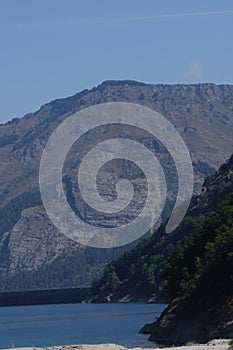 mountain landscape, view of forested mountain and lake, clear sky