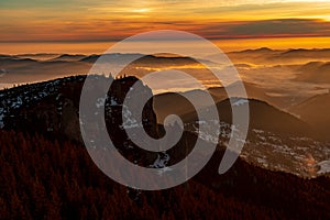 Mountain landscape with winter fog at sunse of Ceahlau, Romaniat