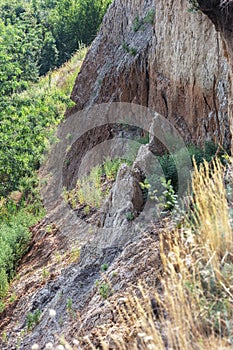 Mountain landslide disaster in sesmically dangerous area. Large cracks in earth, descent of large layers of earth blocking road. M