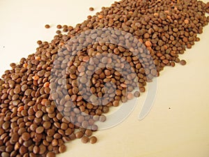 Mountain lentils distributed flatly on a wooden board