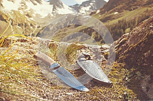 A mountain man knife and leather sheath displayed