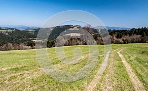 Mountain meadow with hills on the background and clear sky in Javorniky mountains in Slovakia