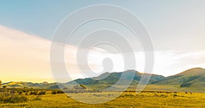 Mountain meadow time-lapse at the summer or autumn sunrise time. Wild nature and rural field. Clouds movement, green