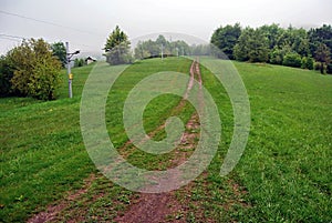 Mountain meadow with trees. pathway and ski lift above Mojtin in Slovakia