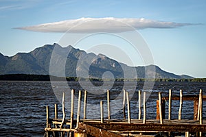 Mountain of Mestre Alvaro with cloud in the shape of an umbrella, wooden pier in the foreground photo