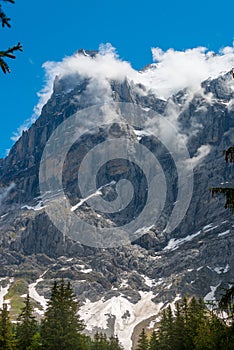 Mountain Mittelhorn: rocks, snow and clouds in Switzerland