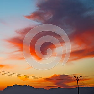 mountain in morocco africa current cables and red sunrise