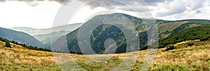 Mountain panorama in the cloudy day. Beautiful natural panoramic landscape in the summer time. Beautiful panorama for a postcard