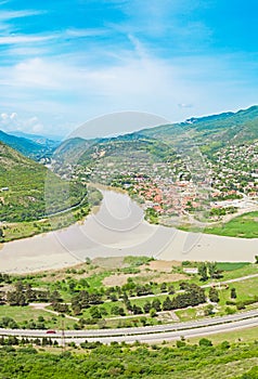 Mountain panorama with green field and blue sky