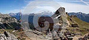 Mountain panorama with hiking hut: RotwandhÃ¼tte in the Dolomites. In the foreground a fla