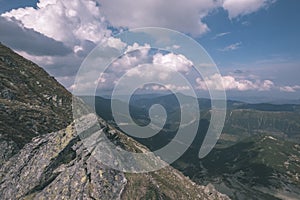 Mountain panorama from top of Banikov peak in Slovakian Tatra mountains with rocky landscape and shadows of hikers in bright day