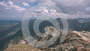 Mountain panorama from top of Banikov peak in Slovakian Tatra mountains with rocky landscape and shadows of hikers in bright day