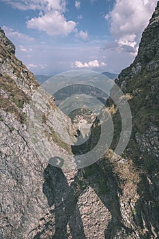 Mountain panorama from top of Banikov peak in Slovakian Tatra mountains with rocky landscape and shadows of hikers in bright day