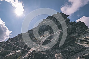 Mountain panorama from top of Banikov peak in Slovakian Tatra mountains with rocky landscape and shadows of hikers in bright day