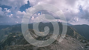 Mountain panorama from top of Banikov peak in Slovakian Tatra mountains with rocky landscape and shadows of hikers in bright day