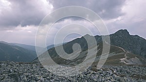 Mountain panorama from top of Banikov peak in Slovakian Tatra mountains with rocky landscape and shadows of hikers in bright day