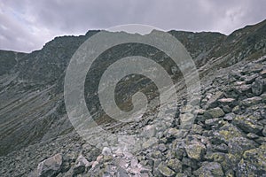 Mountain panorama from top of Banikov peak in Slovakian Tatra mountains with rocky landscape and shadows of hikers in bright day