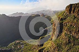 A mountain pass with a beautiful road, cars and villages during sunset