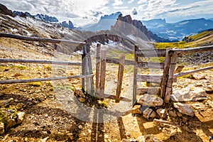 Mountain pass wicket gate trail ridge, alpine landscape, South Tyrol, Italy