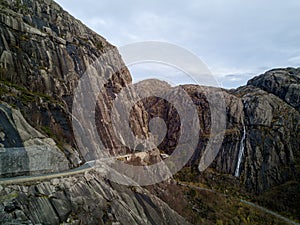 Mountain Passage: Aerial view of road tunneling into majestic peaks