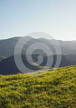 Mountain pasture abd clear sky photo