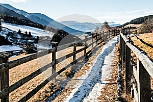 Mountain path and long wooden fence in Dolomite Alps